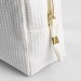 Trousse en nid d'abeille, trousse de toilette publicidad